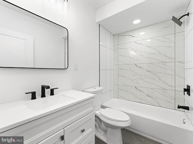 full bathroom with vanity, tiled shower / bath combo, and toilet