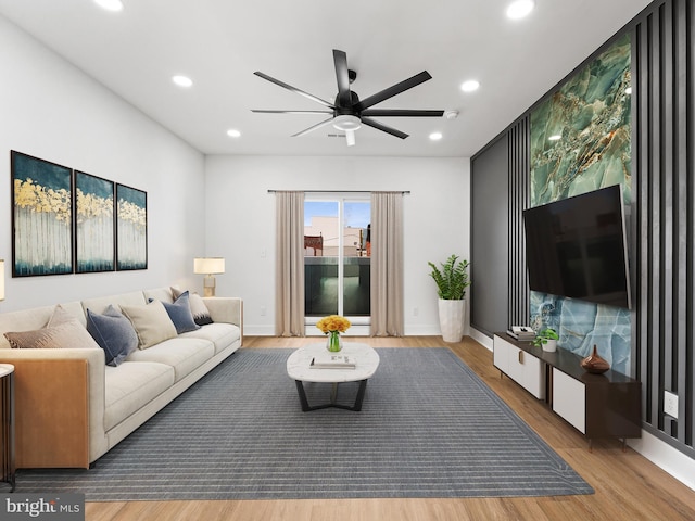 living room with hardwood / wood-style flooring and ceiling fan