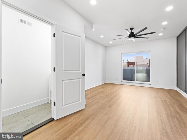 spare room featuring light hardwood / wood-style flooring and ceiling fan