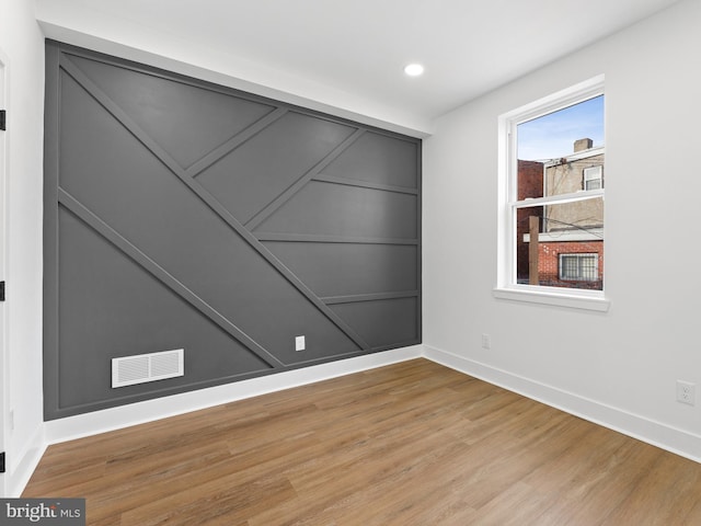 spare room featuring hardwood / wood-style floors