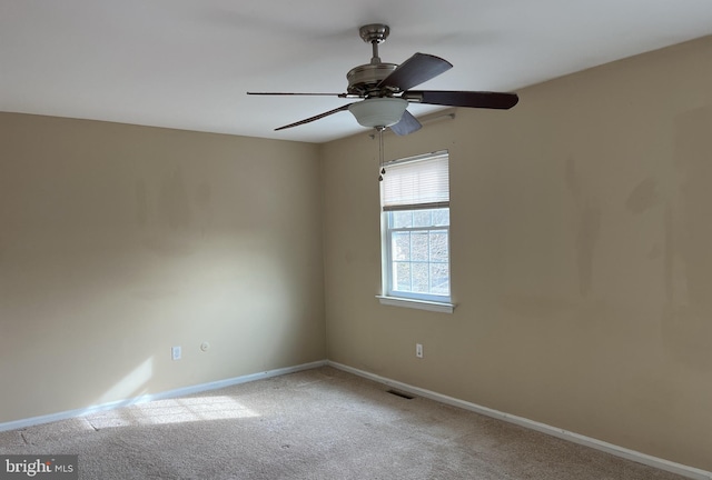 carpeted spare room with ceiling fan