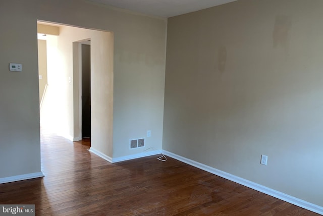 unfurnished room featuring dark hardwood / wood-style floors