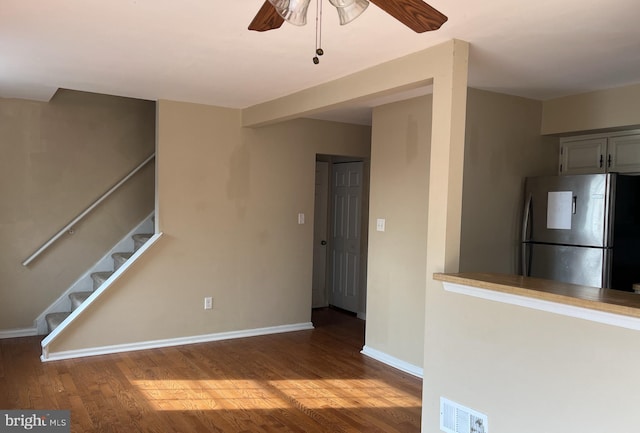 interior space with hardwood / wood-style flooring, ceiling fan, and stainless steel refrigerator