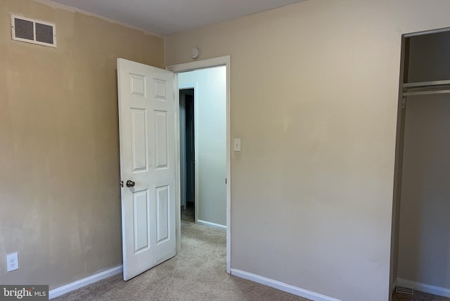 unfurnished bedroom with light colored carpet