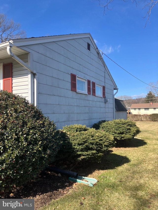 view of home's exterior with a yard