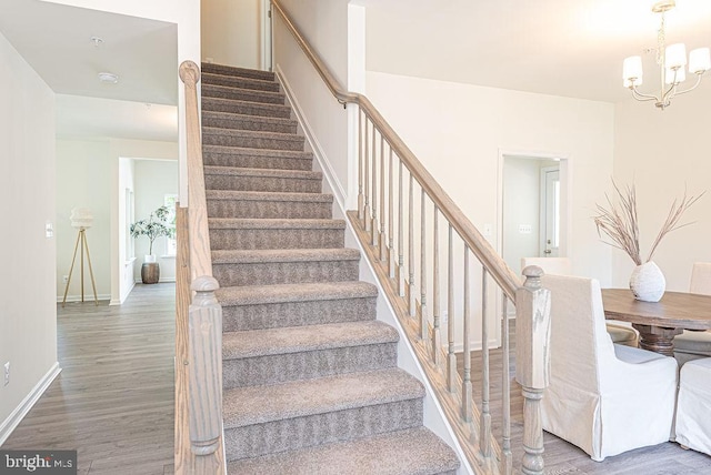 1404 N Chase St, Ocean Pines, MD 21811 - stairway with wood finished floors, a chandelier, and baseboards
