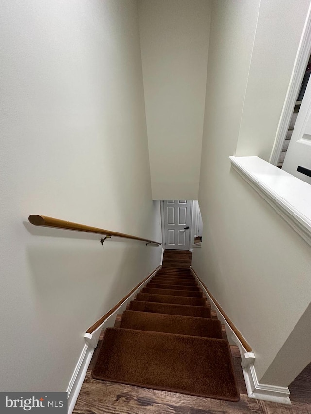 staircase with hardwood / wood-style floors