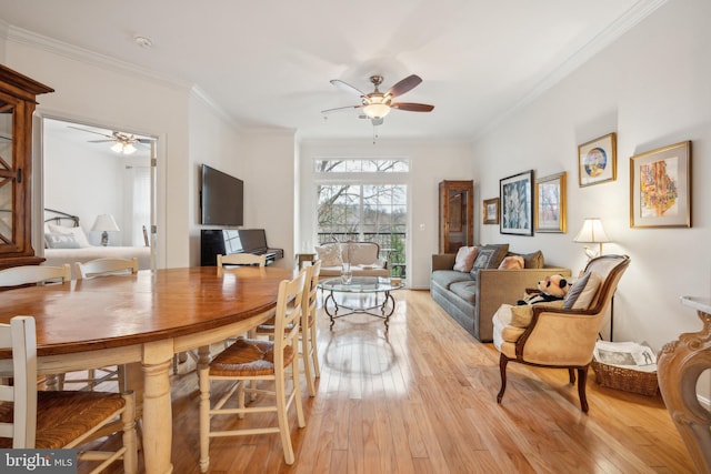 dining room featuring ceiling fan, ornamental molding, and light wood-type flooring