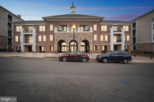 view of outdoor building at dusk