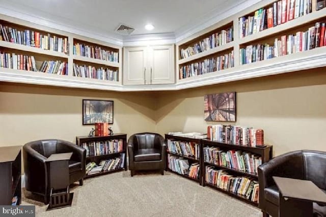 sitting room with crown molding and carpet flooring