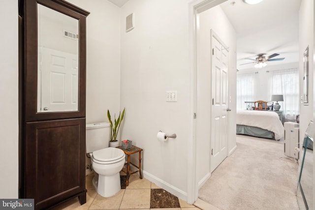 bathroom with tile patterned flooring, ceiling fan, and toilet