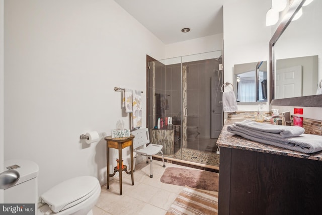 bathroom with tile patterned flooring, vanity, an enclosed shower, and toilet