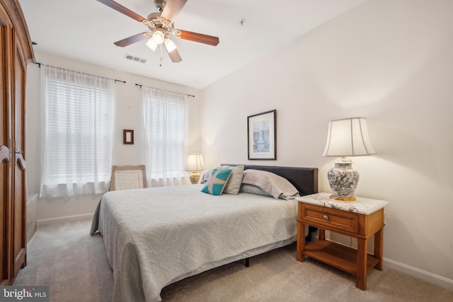 bedroom featuring light carpet and ceiling fan