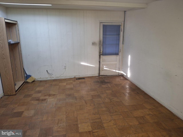 empty room featuring dark parquet flooring