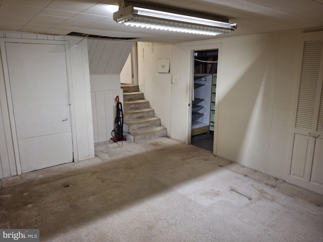 basement featuring light colored carpet