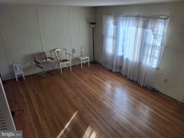 unfurnished room featuring dark hardwood / wood-style flooring and a wealth of natural light