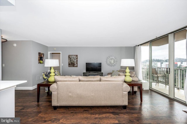 living room featuring a wall of windows and dark hardwood / wood-style floors