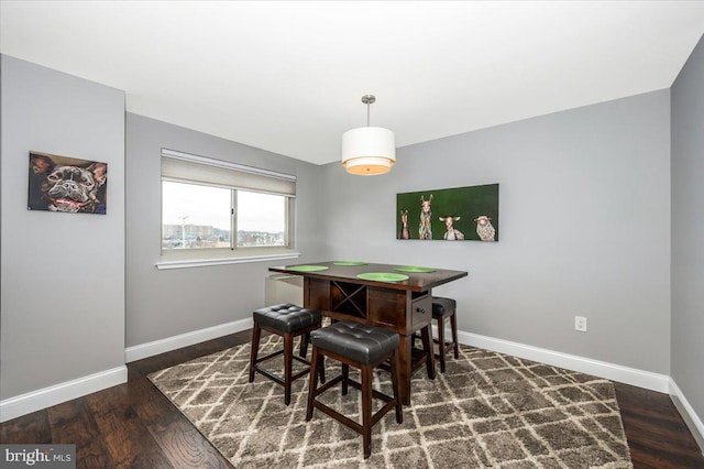 dining room with dark hardwood / wood-style flooring