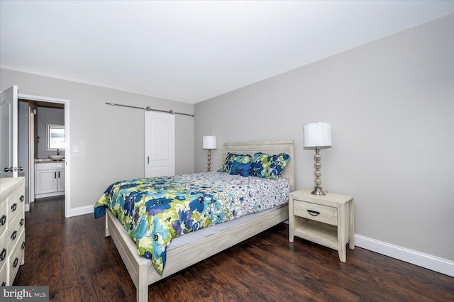 bedroom with a barn door and dark hardwood / wood-style floors