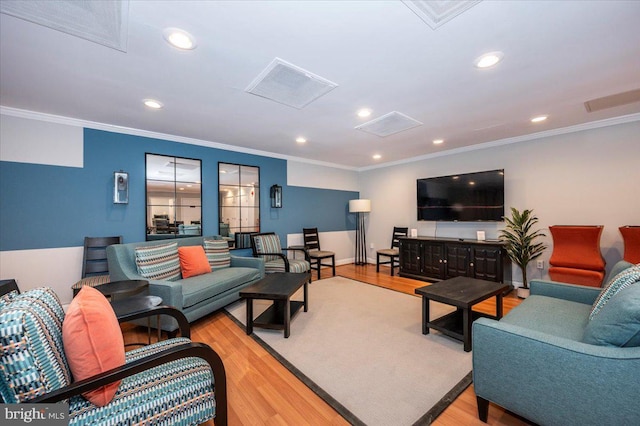 living room featuring ornamental molding and light wood-type flooring