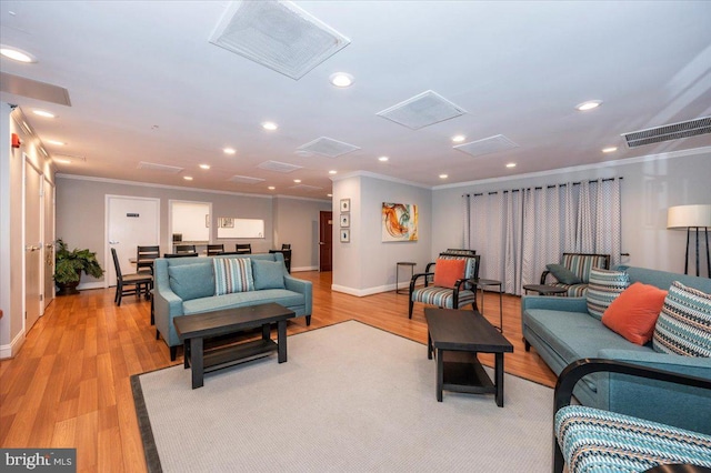 living room with crown molding and light hardwood / wood-style flooring