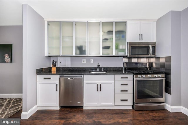 kitchen featuring stainless steel appliances, sink, and white cabinets