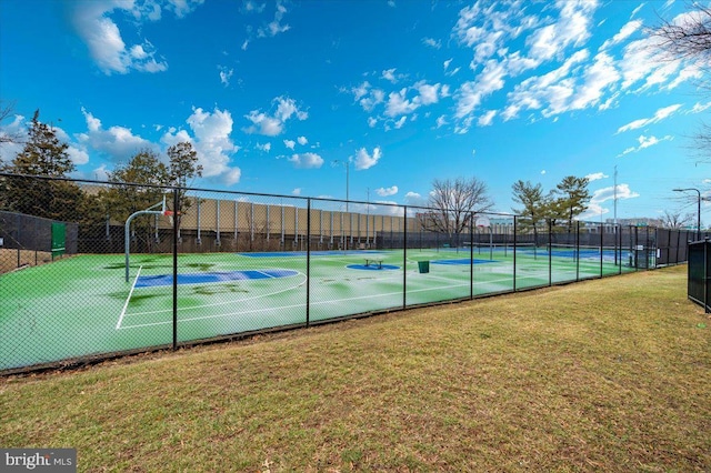 view of basketball court featuring tennis court and a lawn