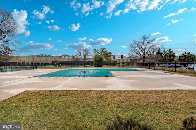 view of pool with a patio and a yard