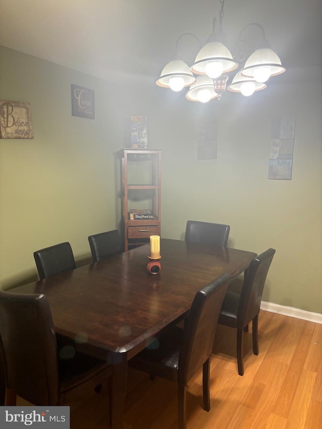 dining area with a chandelier and light hardwood / wood-style floors