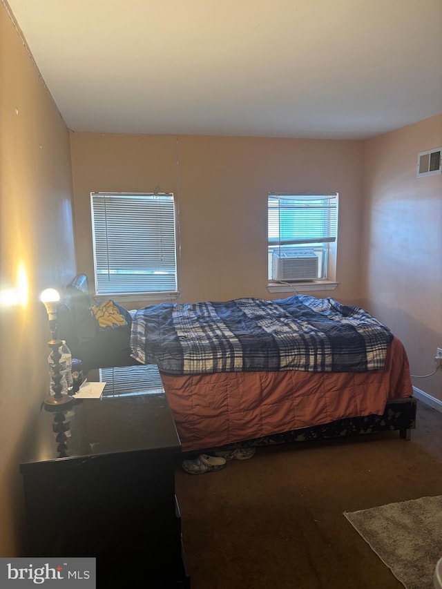 bedroom featuring cooling unit and carpet floors