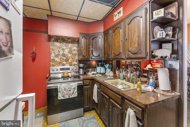 kitchen featuring sink, dark brown cabinets, stainless steel electric stove, and a paneled ceiling