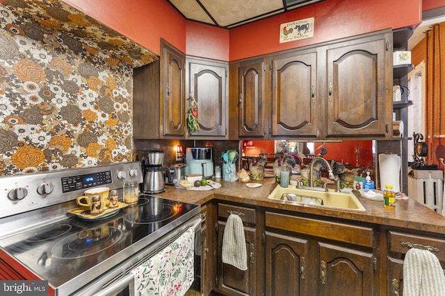 kitchen with electric stove, sink, and dark brown cabinetry