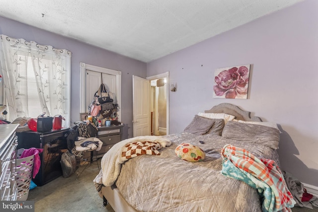 carpeted bedroom with a textured ceiling