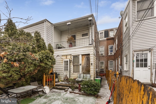 rear view of property featuring a balcony