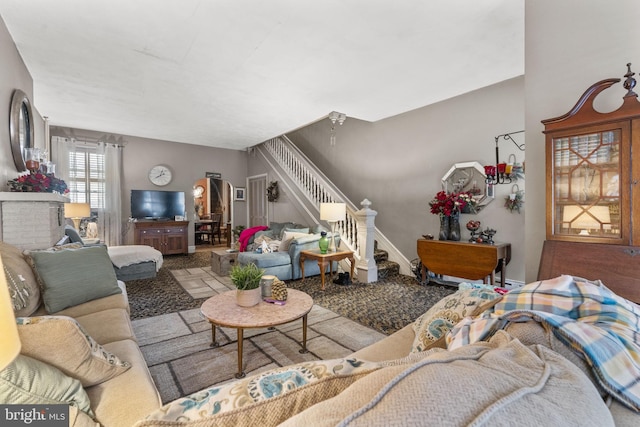 living room featuring a brick fireplace