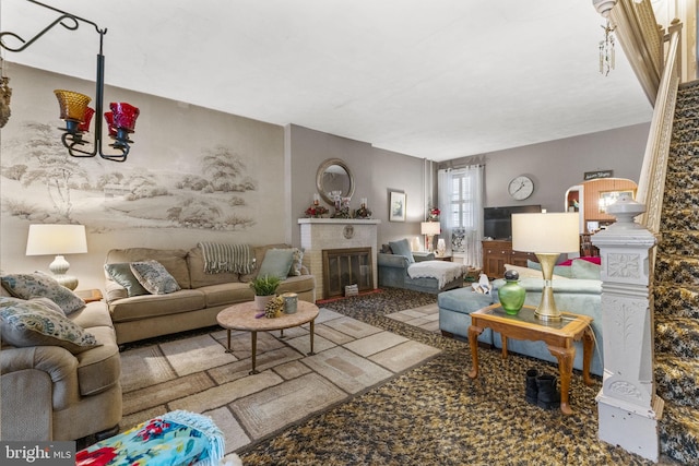 living room with a brick fireplace