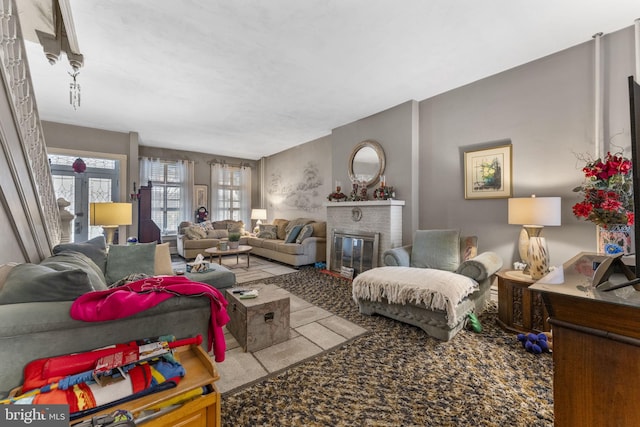 living room featuring a brick fireplace and light colored carpet