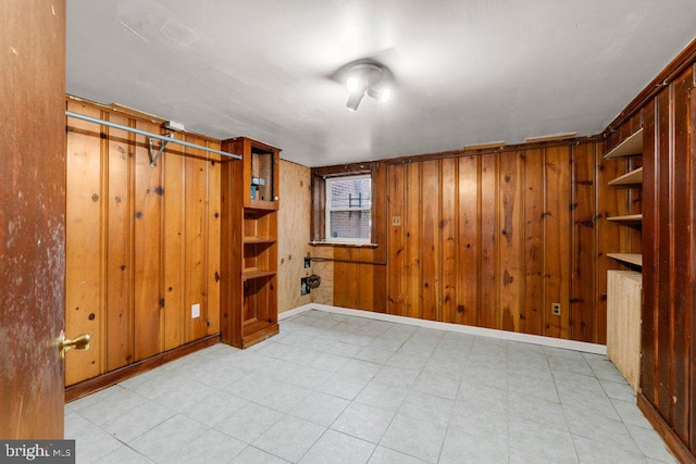 basement featuring wooden walls