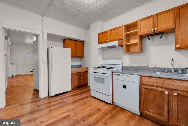 kitchen featuring sink, white appliances, and light hardwood / wood-style floors