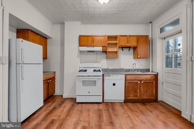 kitchen with ornamental molding, sink, white appliances, and light hardwood / wood-style flooring