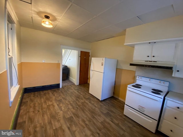 kitchen with white appliances, dark wood-type flooring, white cabinets, and a paneled ceiling