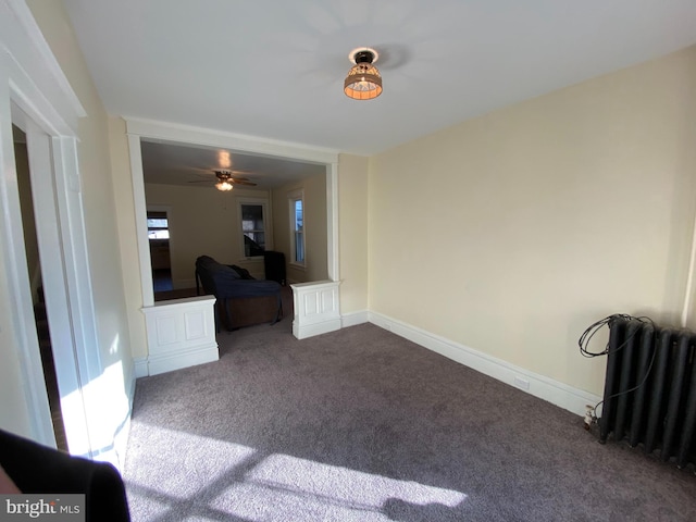 spare room featuring radiator heating unit and carpet flooring