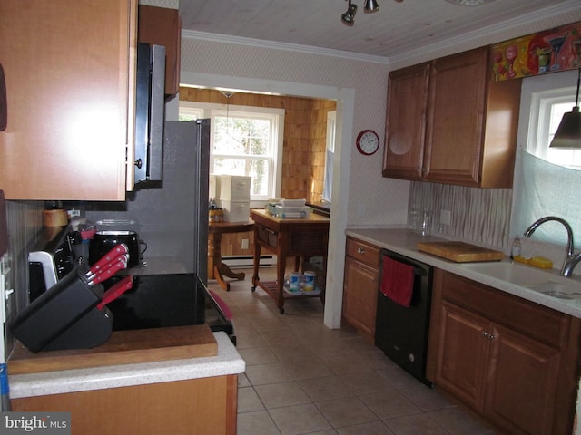 kitchen with sink, light tile patterned floors, black dishwasher, ornamental molding, and a baseboard radiator