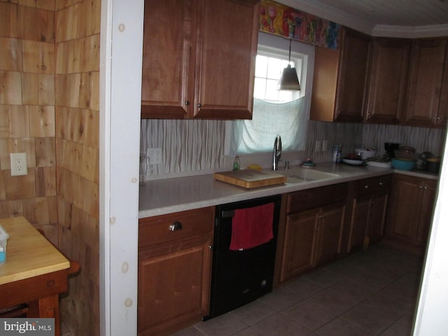 kitchen featuring decorative light fixtures, dishwasher, sink, and light tile patterned floors