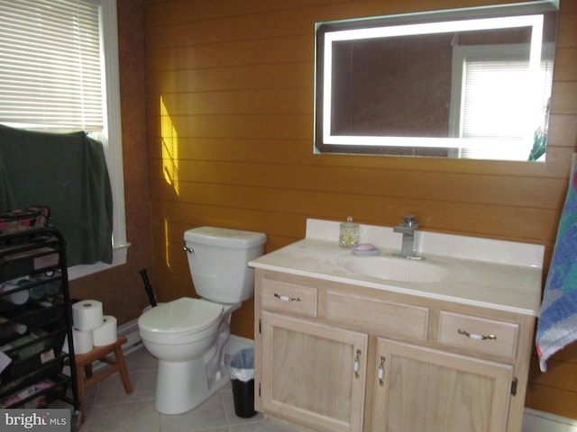 bathroom featuring vanity, tile patterned floors, wooden walls, and toilet