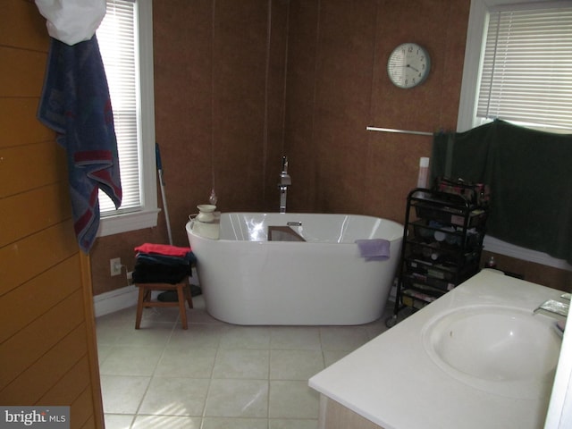 bathroom featuring tile patterned floors, a bathing tub, and sink