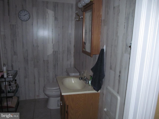 bathroom with tile patterned flooring, vanity, and toilet