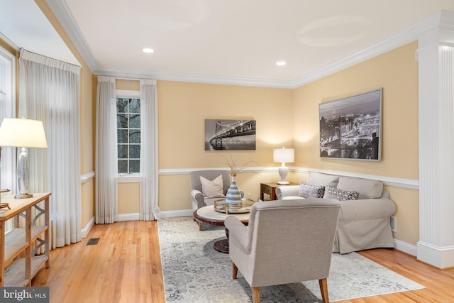 living room featuring hardwood / wood-style flooring and ornamental molding