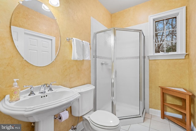 bathroom featuring sink, an enclosed shower, tile patterned floors, and toilet