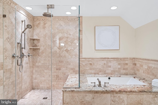 bathroom featuring vaulted ceiling and separate shower and tub